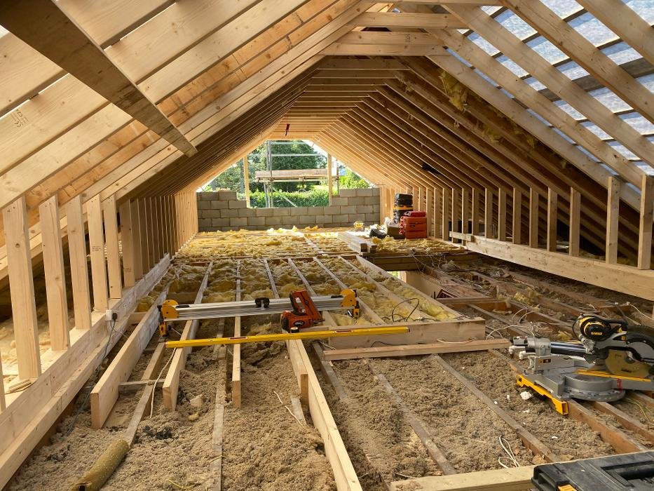 Timber frame builders UK constructing a modern timber-frame home with sustainable design, showing expert craftsmanship and structural precision